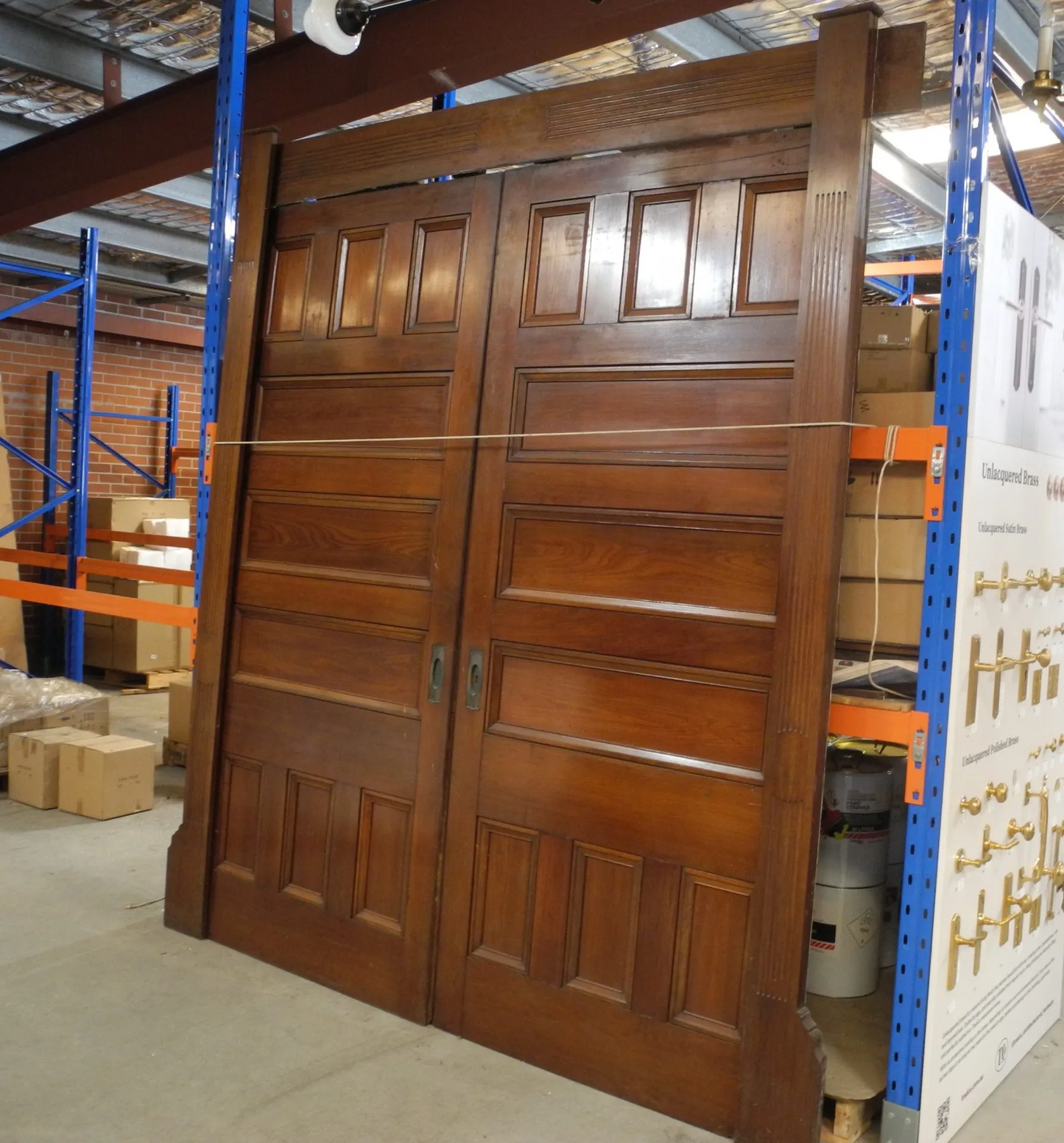 Magnificent pair of polished solid American Walnut internal double doors showcasing rich wood grains and deep panel moulding, from Chippendale Restorations second hand doors yard.