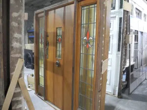 Authentic 1940s Arts and Crafts solid timber front entranceway door set featuring structured geometric glass inserts, available to buy at Chippendale Restorations second hand doors yard.