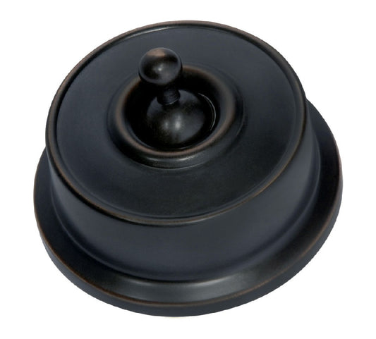 Close-up of a Federation Light Switch with a square or rectangular plate and a decorative edge, featuring a classic toggle or dolly switch, shown in a heritage metal finish.