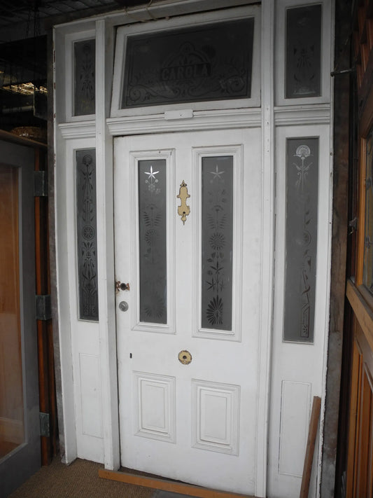 Salvaged antique Victorian front door assembly with custom "CAROLA" etched transom window frame at Chippendale Restorations.