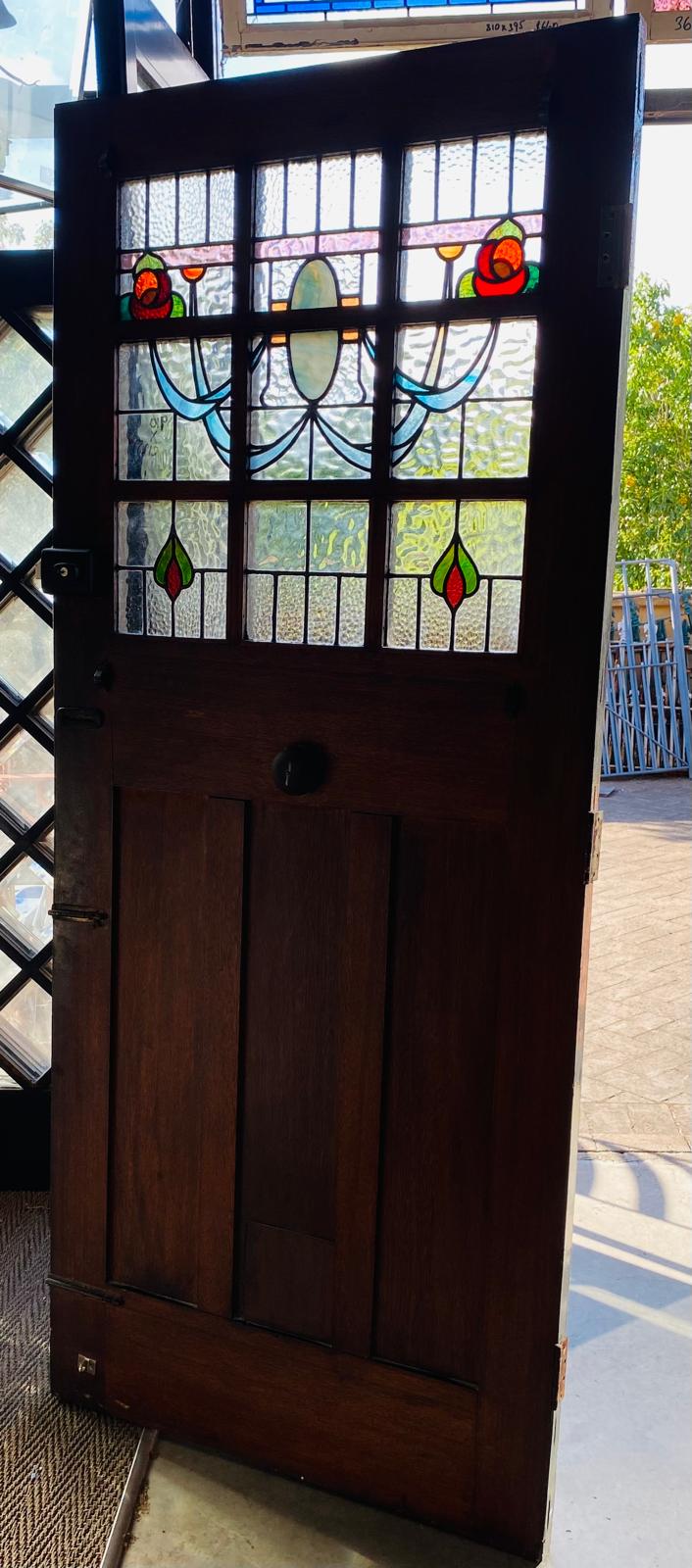 Stately pair of 1920s solid timber front doors with multi-textured geometric leadlight glass panels from Chippendale Restorations second hand doors warehouse.