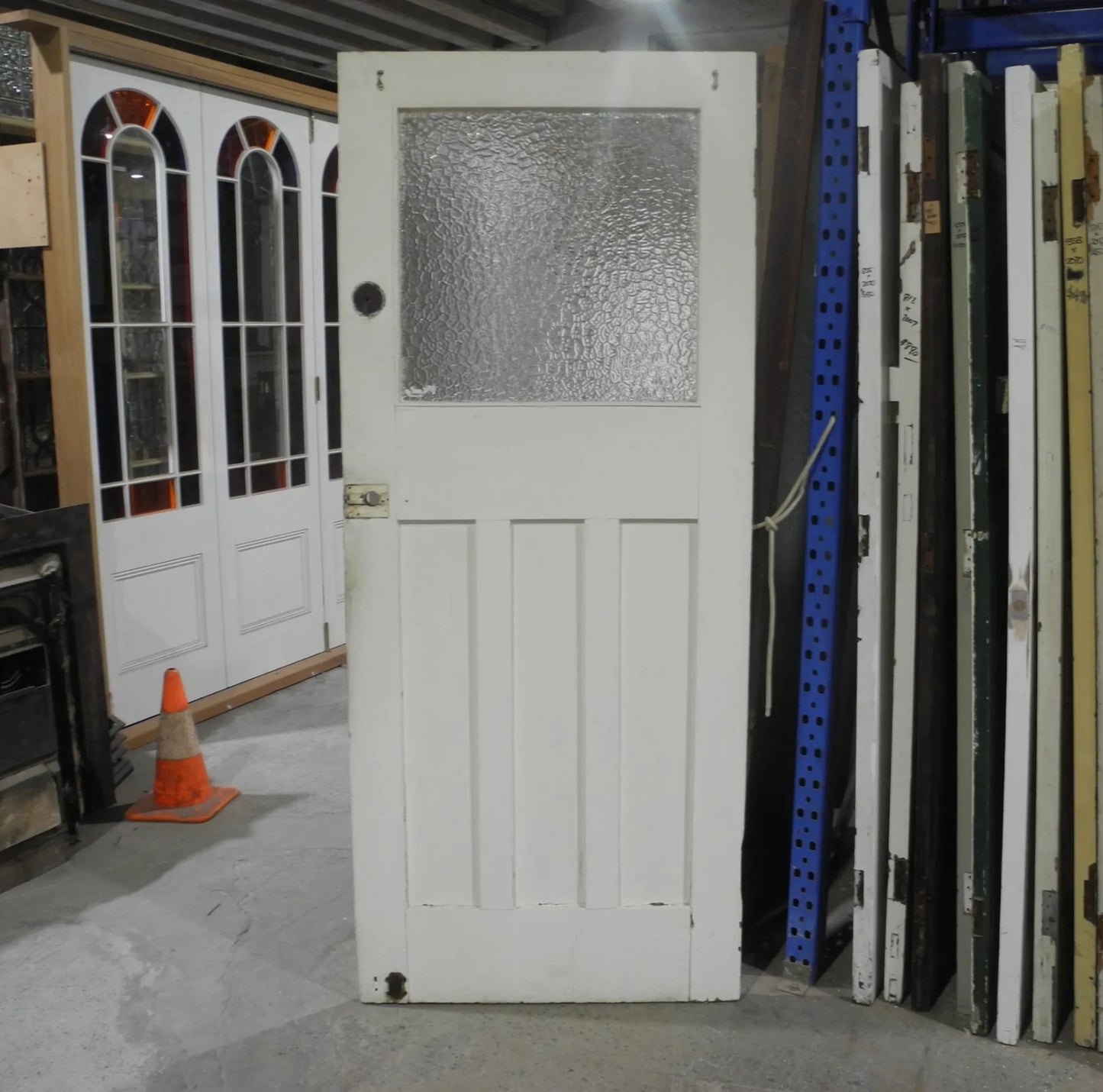Original Edwardian solid timber front door featuring an elegant geometric leadlight glass window panel, available to buy at Chippendale Restorations second hand doors yard.