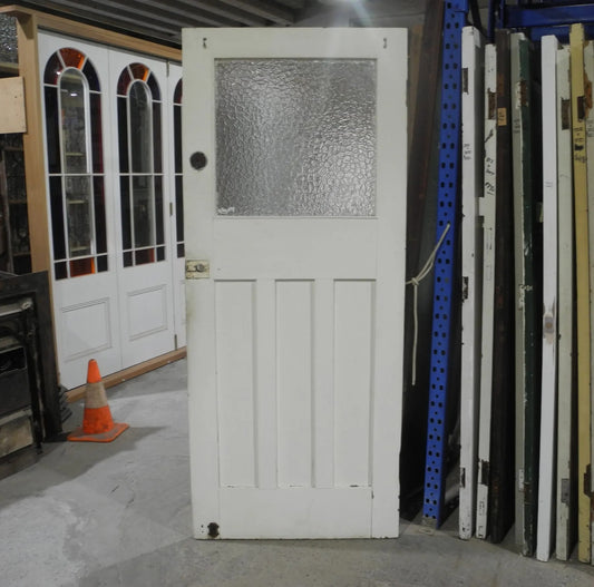 Original Edwardian solid timber front door featuring an elegant geometric leadlight glass window panel, available to buy at Chippendale Restorations second hand doors yard.