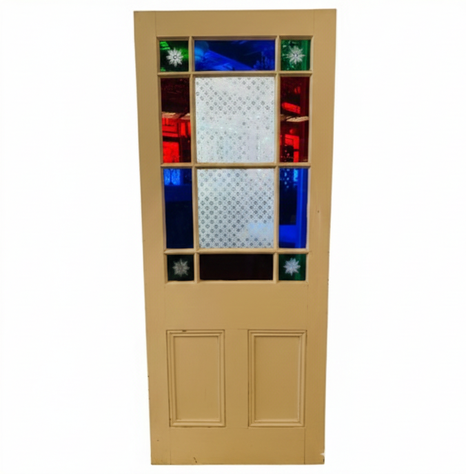 An original salvaged Victorian timber gallery door featuring multi-lite red, blue, and patterned privacy glass windows with four green starburst brilliant-cut corners on display at Chippendale Restorations.