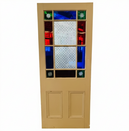 An original salvaged Victorian timber gallery door featuring multi-lite red, blue, and patterned privacy glass windows with four green starburst brilliant-cut corners on display at Chippendale Restorations.