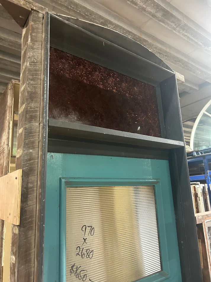 An original salvaged Federation style external entryway timber door painted white, showcasing a large upper window panel with beautiful red, amber, and blue geometric leadlight privacy glass at Chippendale Restorations.
