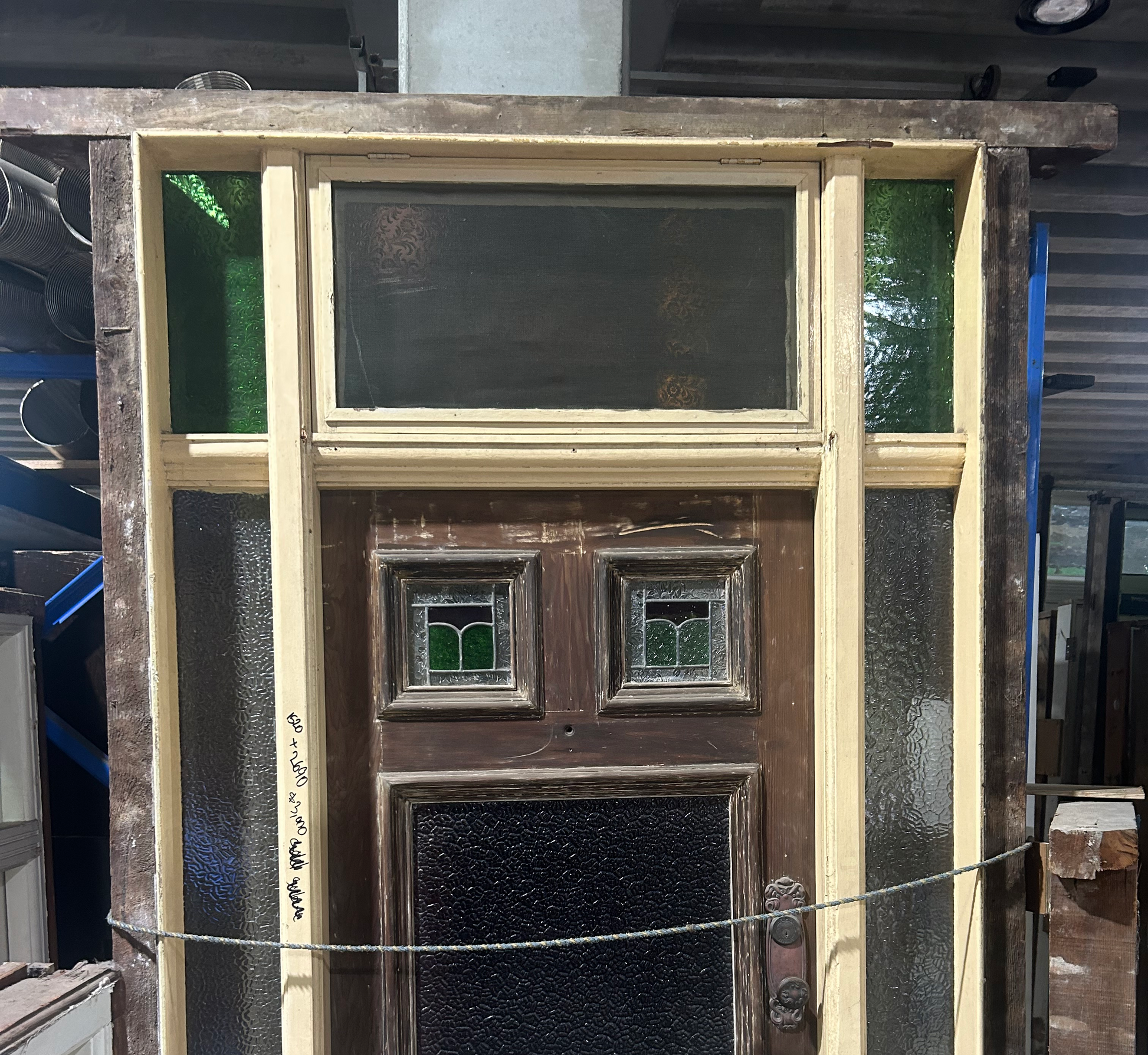 Authentic white Federation timber front door featuring high-set geometric textured leadlight privacy glass windows from Chippendale Restorations second hand doors yard.