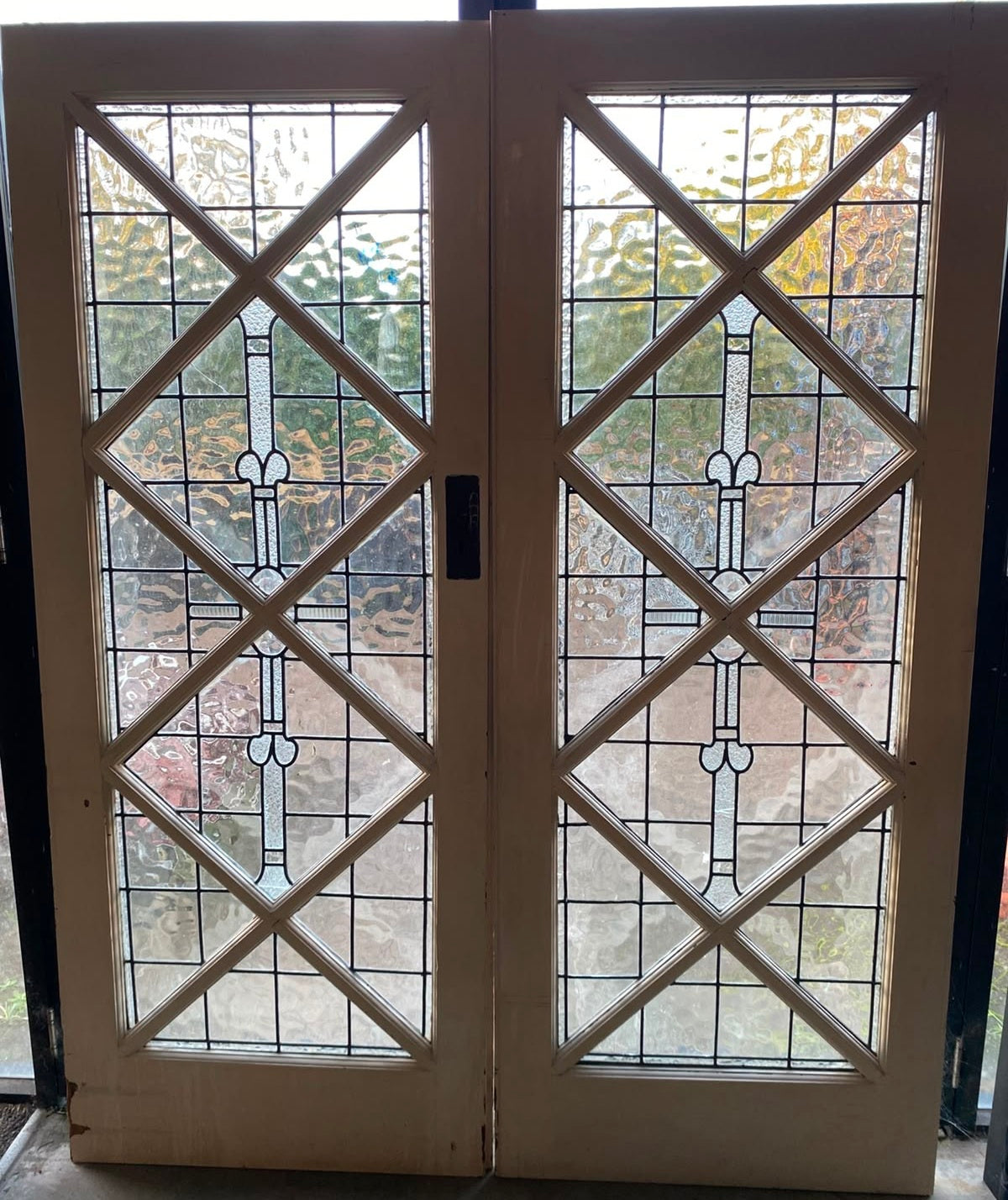 Matching pair of 1920s solid timber internal French doors featuring geometric leadlight glass panels from Chippendale Restorations second hand doors stock.