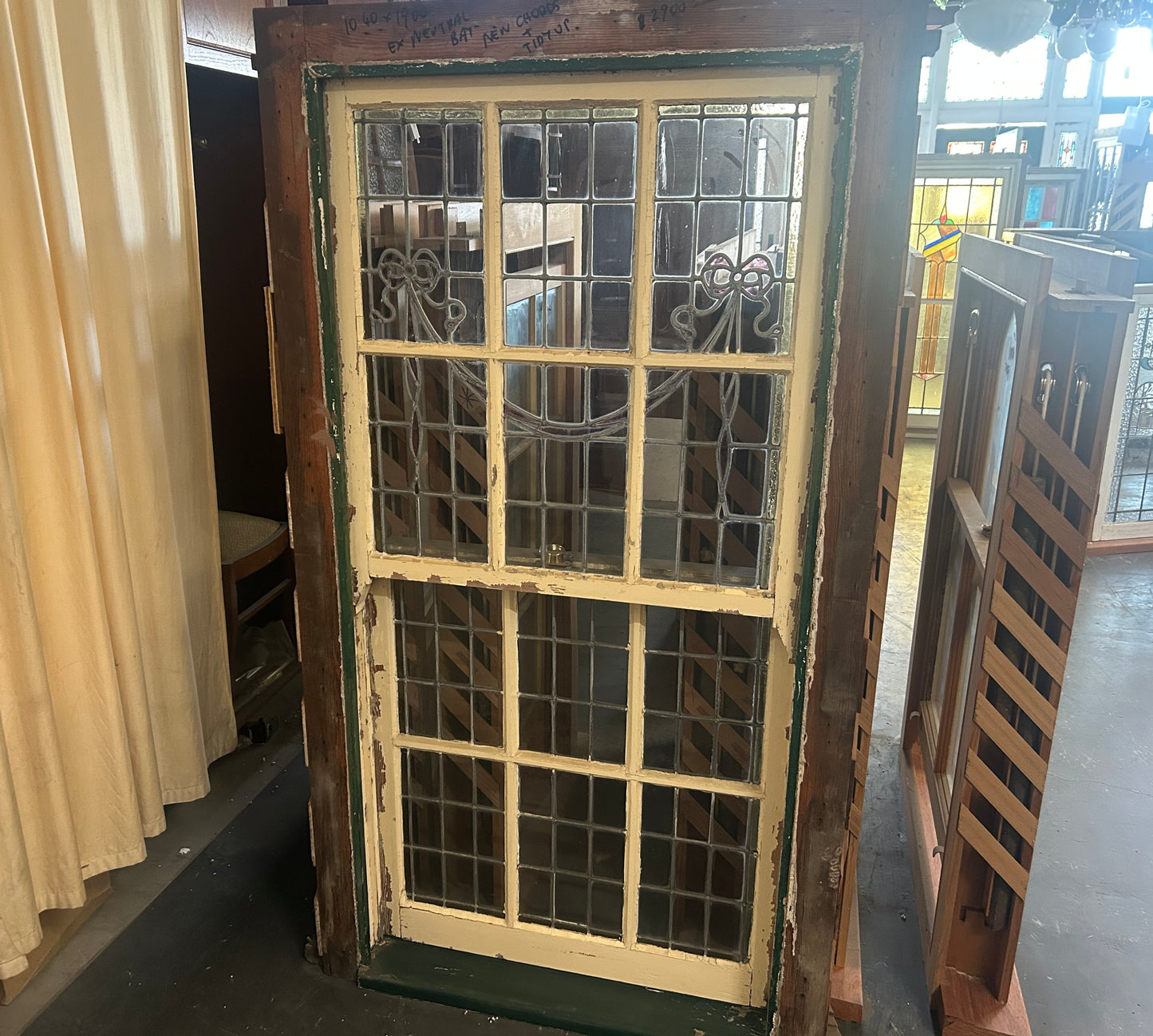 An original salvaged heritage single hung timber window painted white, showing clean glass panels set within a sturdy architectural frame on display at Chippendale Restorations.