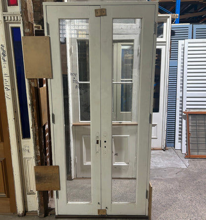 An original salvaged California Bungalow style internal timber door painted white, featuring five horizontal recessed panels on display at Chippendale Restorations.