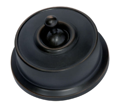 Close-up of a Federation Light Switch with a square or rectangular plate and a decorative edge, featuring a classic toggle or dolly switch, shown in a heritage metal finish.