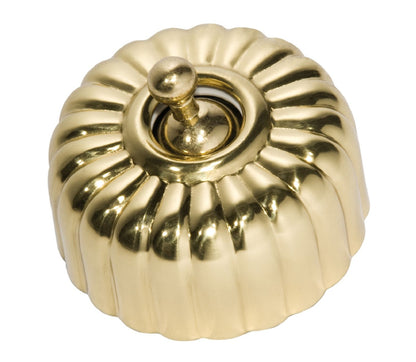 Close-up of a Fluted Light Switch wall plate and dolly switch, distinguished by its unique vertical ridged/ribbed design and presented in a polished or brushed metal finish.