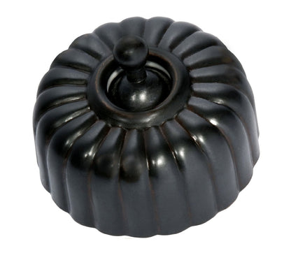 Close-up of a Fluted Light Switch wall plate and dolly switch, distinguished by its unique vertical ridged/ribbed design and presented in a polished or brushed metal finish.