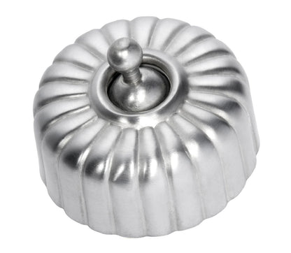 Close-up of a Fluted Light Switch wall plate and dolly switch, distinguished by its unique vertical ridged/ribbed design and presented in a polished or brushed metal finish.