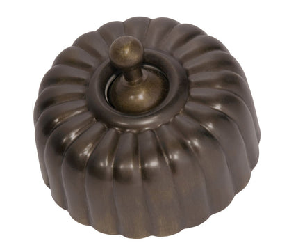 Close-up of a Fluted Light Switch wall plate and dolly switch, distinguished by its unique vertical ridged/ribbed design and presented in a polished or brushed metal finish.