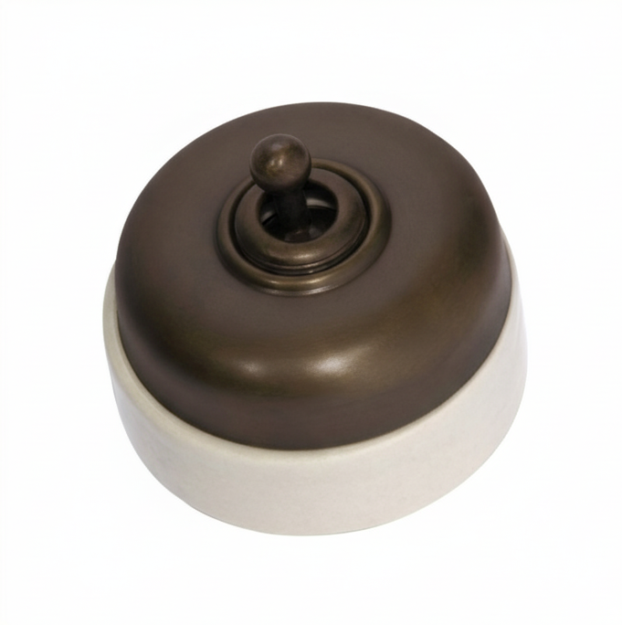 Porcelain-based electrical switch with a visible metal dolly. Available in a polished brass or antique brass finish on either a white porcelain base or a black porcelain base.