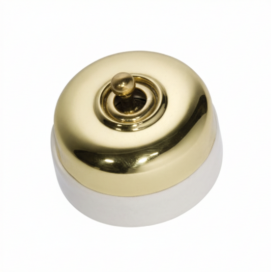 Porcelain-based electrical switch with a visible metal dolly. Available in a polished brass or antique brass finish on either a white porcelain base or a black porcelain base.