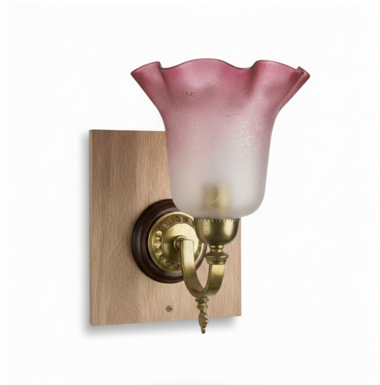 Vintage brass wall sconce with a decorative arm, a polished wood roundel and square backplate, and a red and frosted clear fluted glass lampshade.