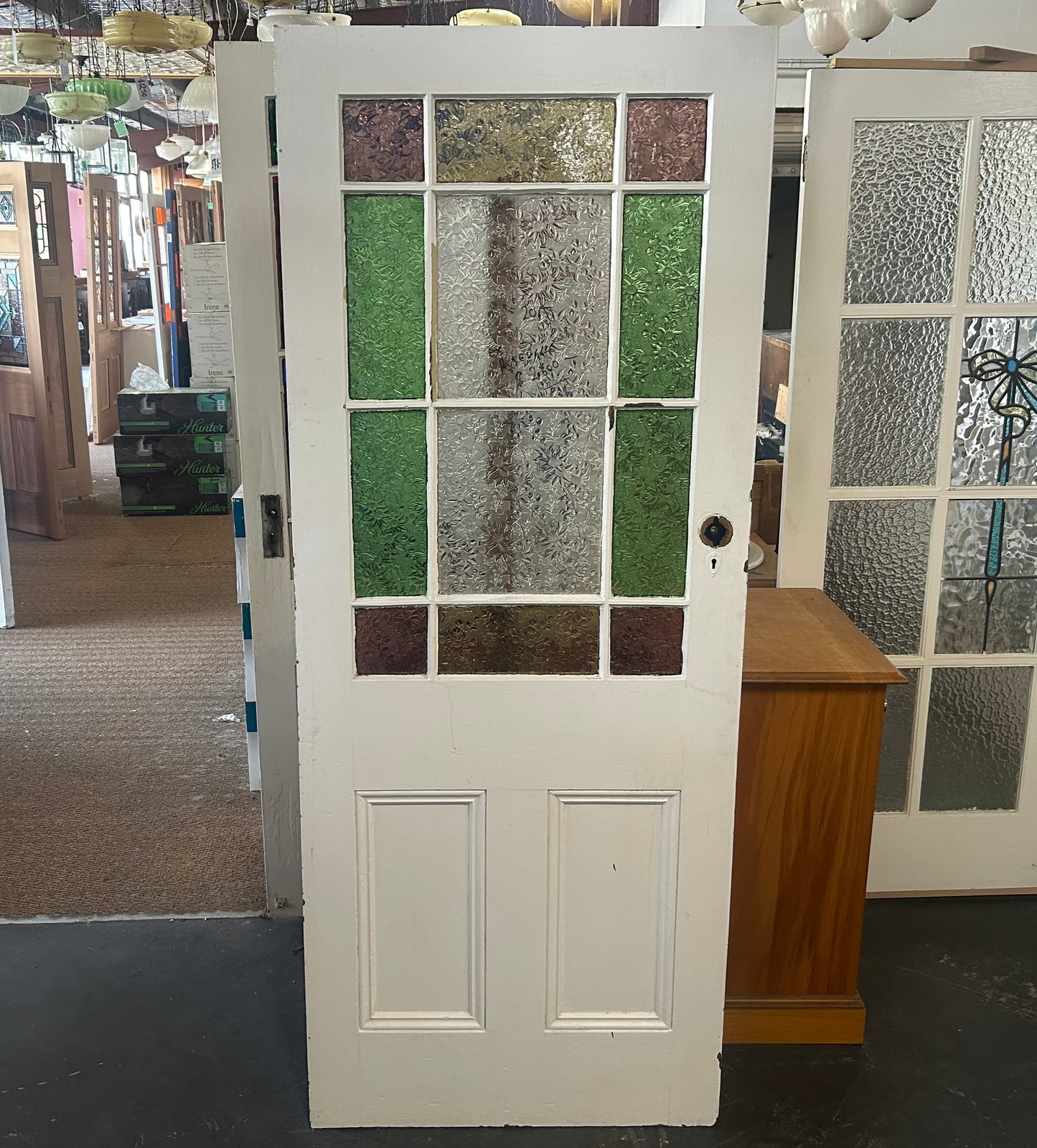 An original salvaged Federation style timber gallery door painted white, featuring a multi-lite clear textured privacy glass window configuration on display at Chippendale Restorations.