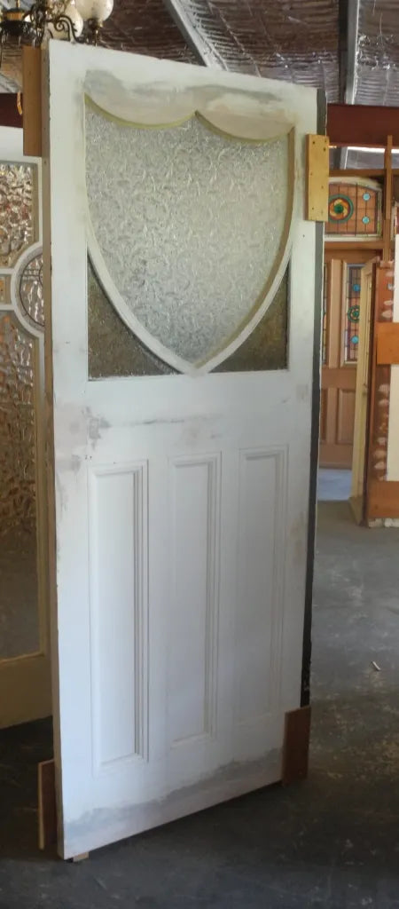 Original 1920s Edwardian solid timber front door featuring a geometric diamond and shield leadlight glass window, available to buy at Chippendale Restorations second hand doors.