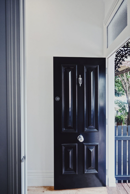 Ornate classic Victorian style door knockers shown in various metallic finishes and mounted on traditional dark timber front doors.