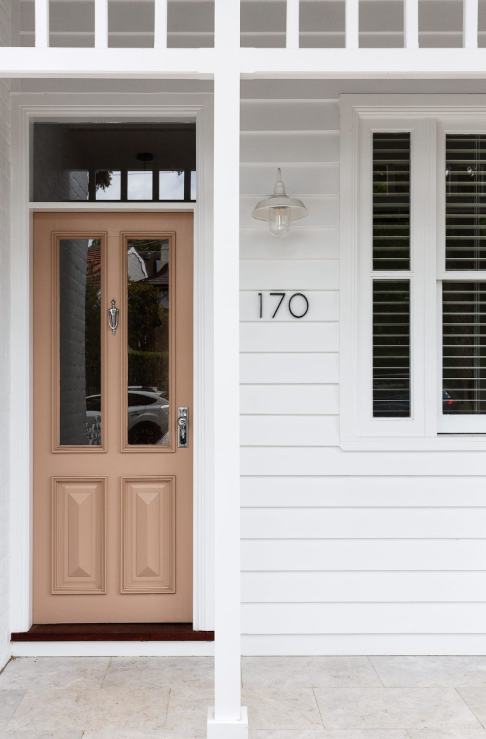 Ornate classic Victorian style door knockers shown in various metallic finishes and mounted on traditional dark timber front doors.