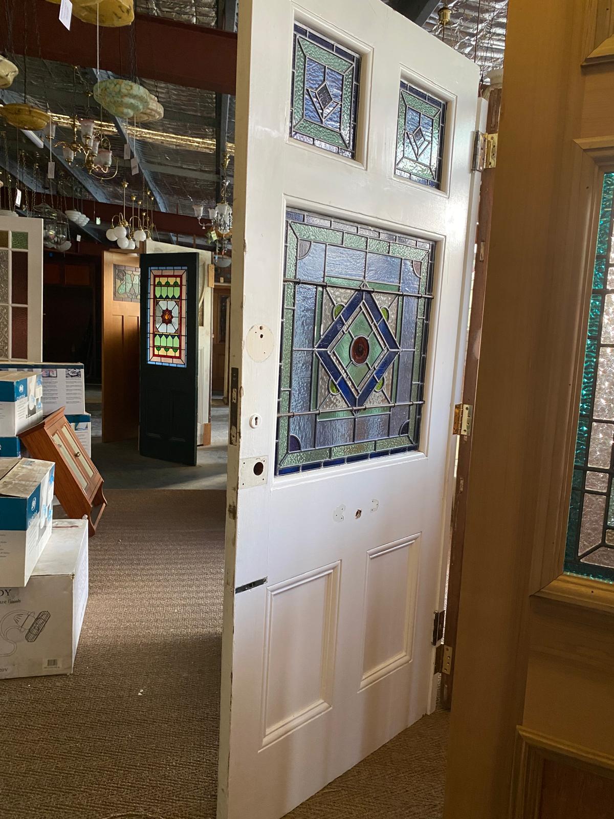 White Federation front door with blue and purple geometric leadlight glass panels from Chippendale Restorations second hand doors collection.