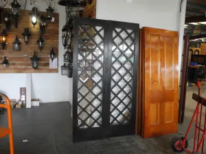 Close-up view of weathered timber framing and individual glass lites on salvaged internal French doors from Chippendale Restorations.