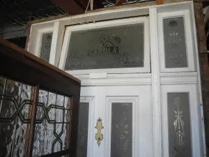 Salvaged antique Victorian front door assembly with custom "CAROLA" etched transom window frame at Chippendale Restorations.