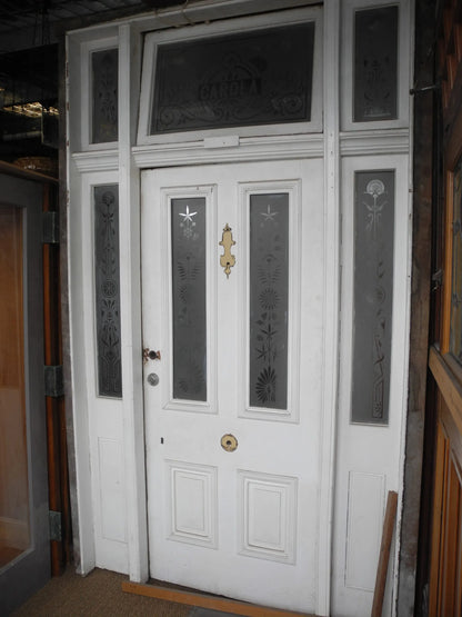 Salvaged antique Victorian front door assembly with custom "CAROLA" etched transom window frame at Chippendale Restorations.